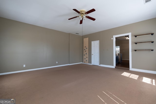 carpeted empty room with ceiling fan, visible vents, and baseboards