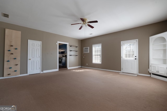 unfurnished living room with baseboards, ceiling fan, visible vents, and carpet flooring