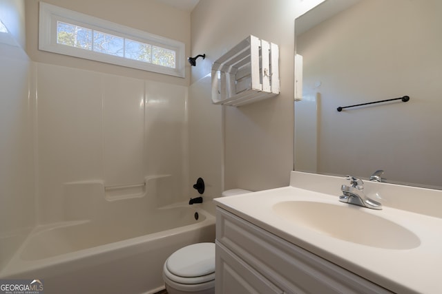 bathroom featuring tub / shower combination, vanity, and toilet