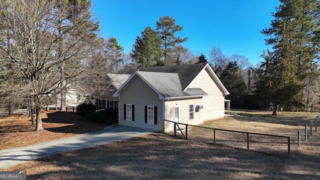 view of side of home featuring fence