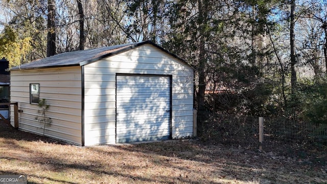 view of outdoor structure featuring an outbuilding and fence