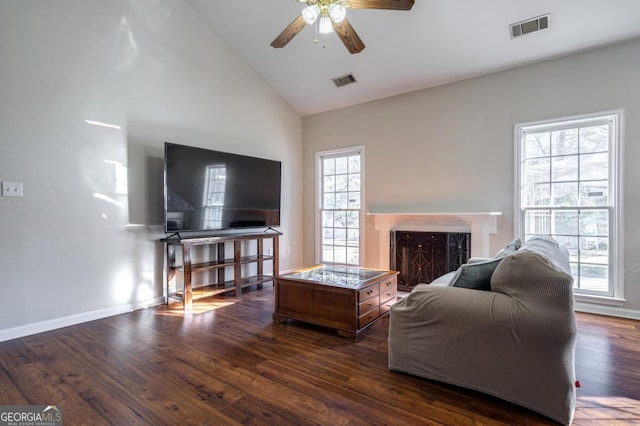 living room with ceiling fan, dark hardwood / wood-style flooring, high vaulted ceiling, and a wealth of natural light