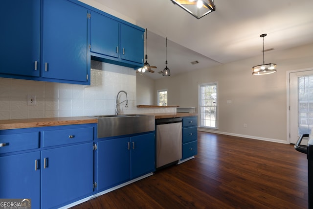 kitchen featuring blue cabinets, butcher block countertops, a sink, stainless steel dishwasher, and decorative light fixtures