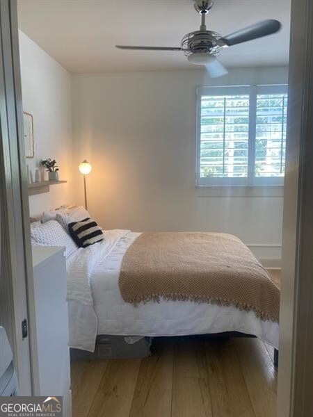 bedroom featuring ceiling fan and hardwood / wood-style floors