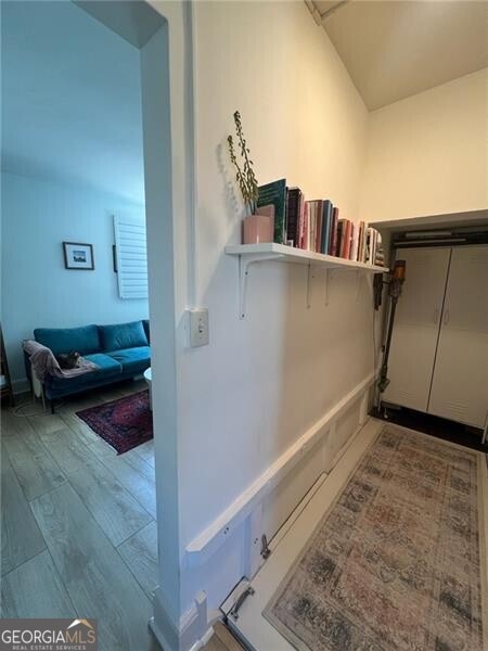 hallway with hardwood / wood-style floors