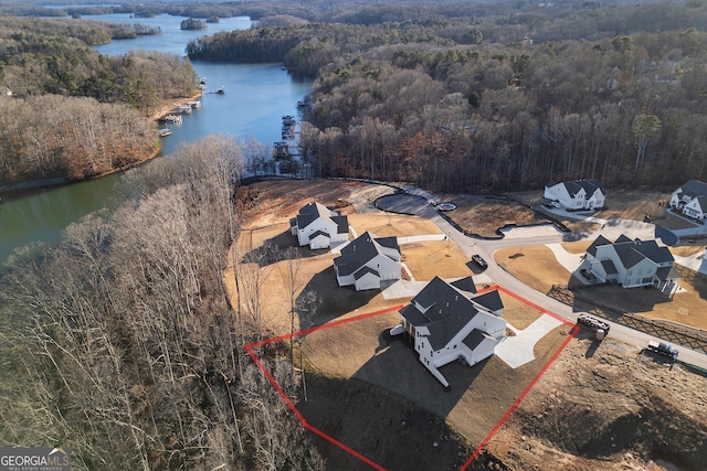 birds eye view of property with a water view