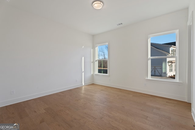 spare room featuring light hardwood / wood-style flooring