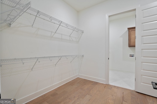 walk in closet featuring light hardwood / wood-style flooring