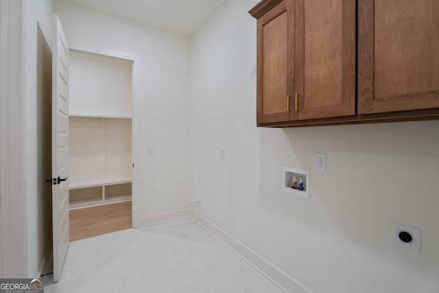 laundry room with cabinets, hookup for an electric dryer, and hookup for a washing machine