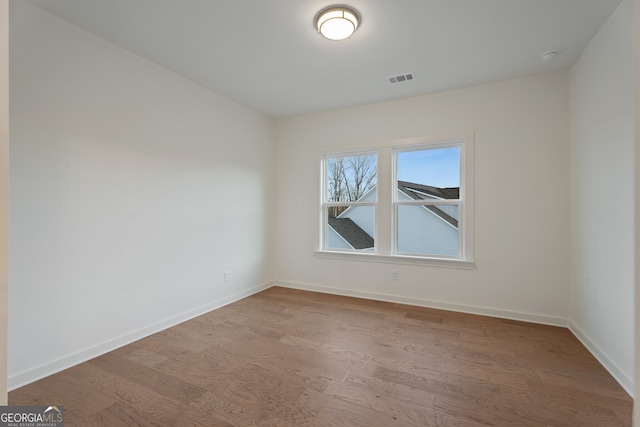 empty room featuring wood-type flooring