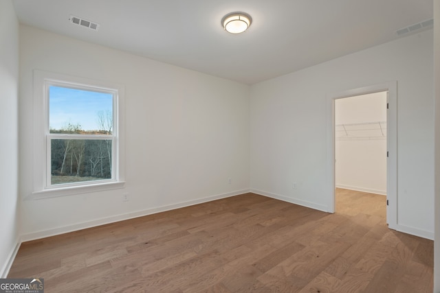 spare room with light hardwood / wood-style flooring