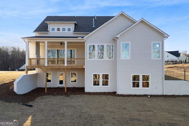 rear view of house featuring a balcony and ceiling fan