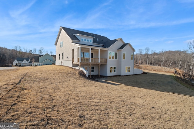 exterior space with a yard, a deck, and ceiling fan