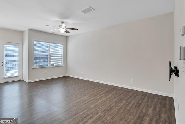 unfurnished room with dark hardwood / wood-style floors and ceiling fan