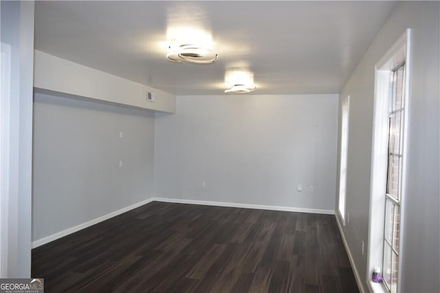 unfurnished room featuring dark wood-type flooring