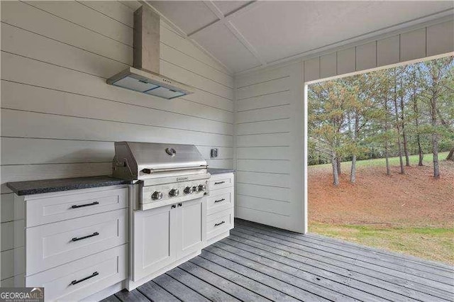 wooden terrace with grilling area and an outdoor kitchen