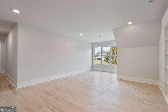 interior space featuring light hardwood / wood-style floors and vaulted ceiling