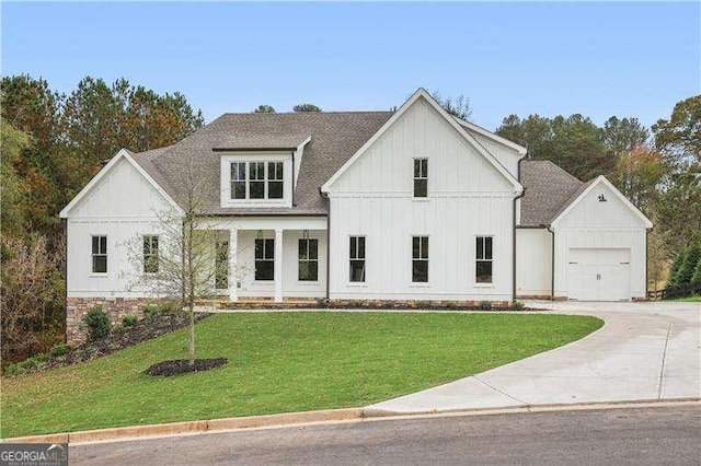 modern inspired farmhouse featuring a garage and a front yard