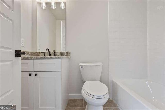 bathroom featuring tile patterned flooring, vanity, and toilet