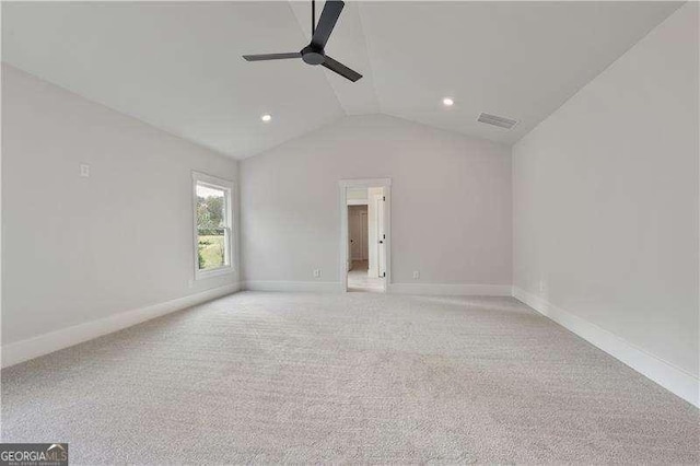 unfurnished room with ceiling fan, light colored carpet, and lofted ceiling