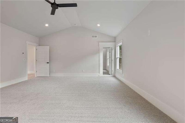 carpeted empty room featuring ceiling fan and lofted ceiling