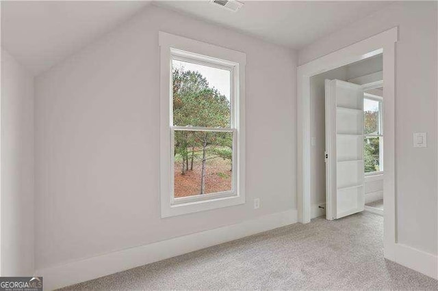 bonus room featuring light carpet and lofted ceiling