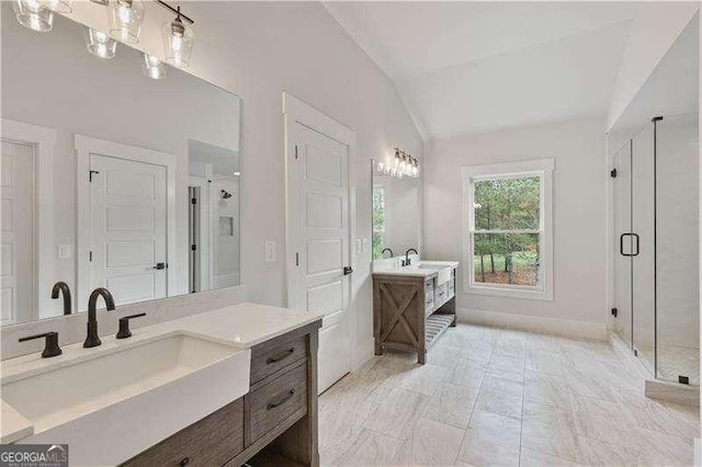 bathroom featuring vanity, a shower with shower door, and lofted ceiling