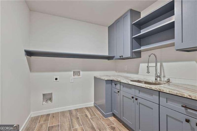 laundry area featuring hookup for a washing machine, sink, cabinets, and hookup for an electric dryer