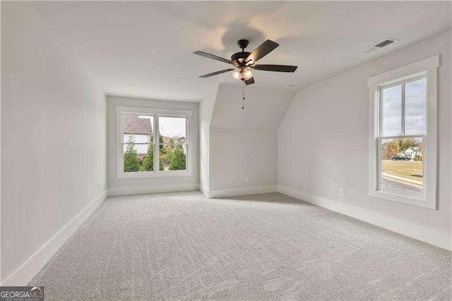 bonus room featuring ceiling fan, light colored carpet, and lofted ceiling