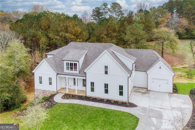 modern farmhouse with a porch and a front yard