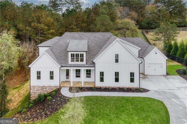 modern farmhouse with a garage and a front lawn