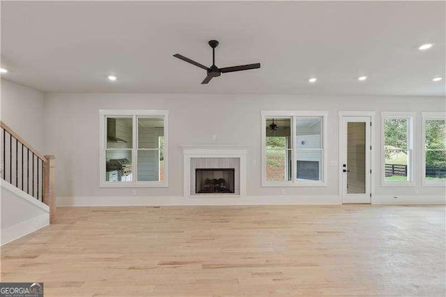 unfurnished living room with light hardwood / wood-style floors and ceiling fan