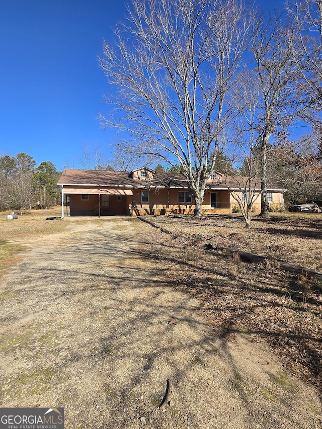 single story home featuring a carport