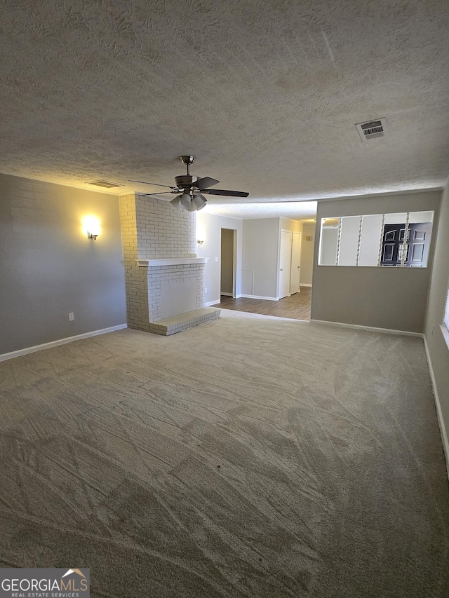 carpeted spare room with ceiling fan and a textured ceiling