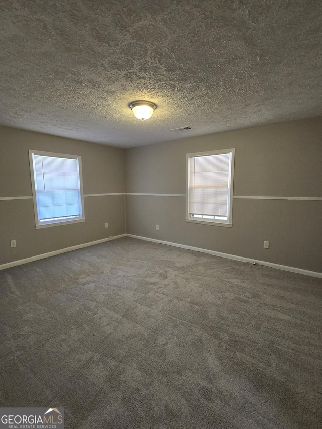 empty room with dark carpet