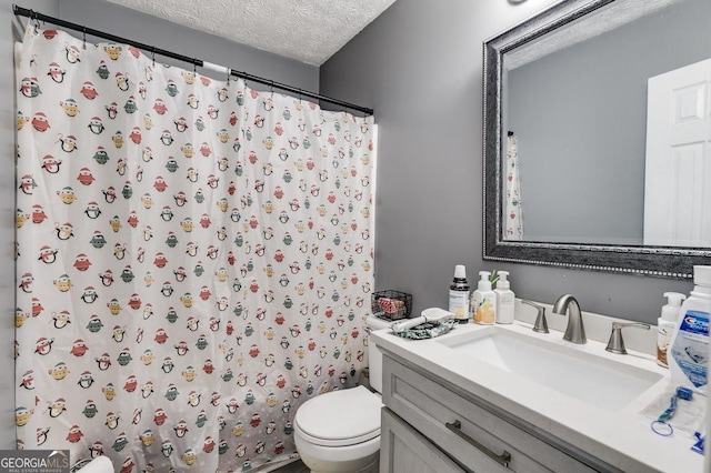 bathroom with curtained shower, vanity, a textured ceiling, and toilet