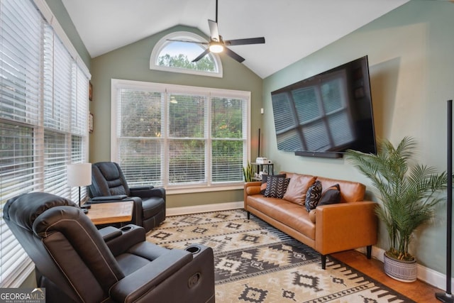 living room with vaulted ceiling, ceiling fan, and a wealth of natural light