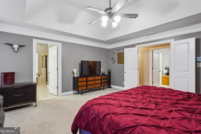 bedroom featuring ornamental molding, connected bathroom, a raised ceiling, and carpet flooring