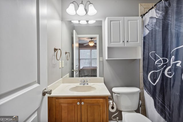 bathroom with toilet, vanity, ceiling fan, and walk in shower