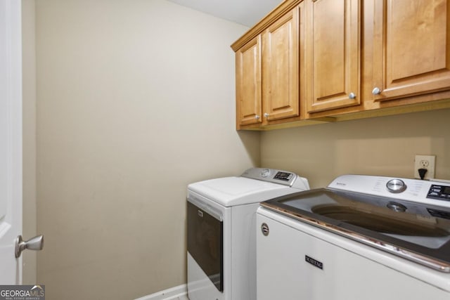 laundry area with cabinets and independent washer and dryer