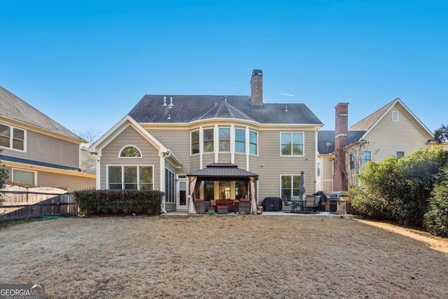 back of house with a gazebo and a patio