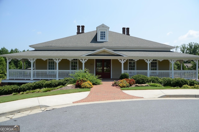 country-style home with french doors and covered porch