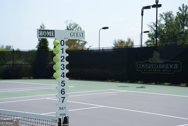 view of tennis court featuring basketball court