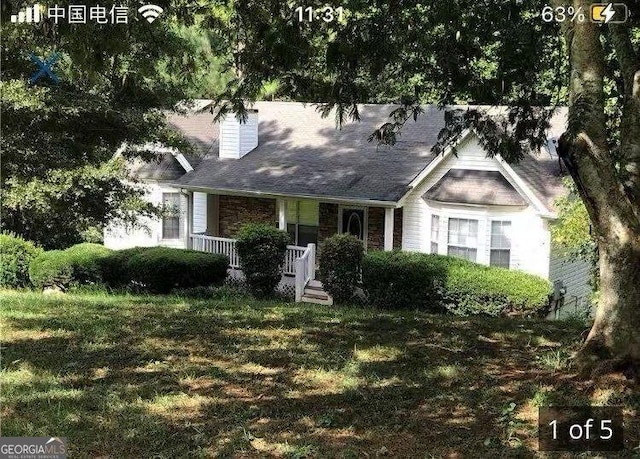 view of front of house featuring a front yard and covered porch