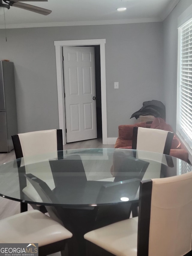 dining room featuring crown molding and ceiling fan