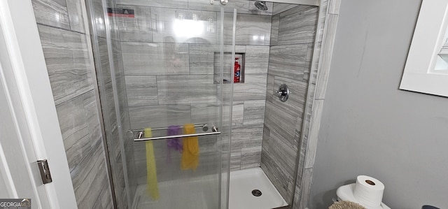 bathroom with a shower with shower door