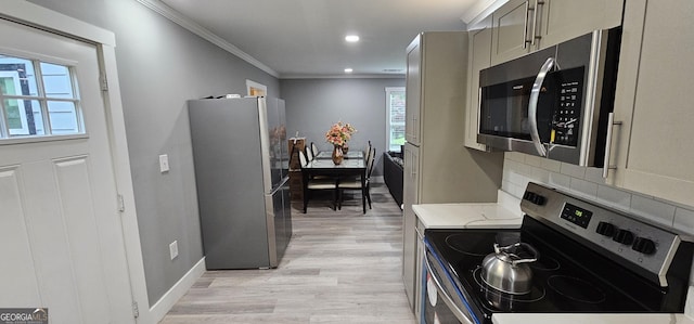 kitchen with light wood-type flooring, ornamental molding, stainless steel appliances, light stone countertops, and backsplash