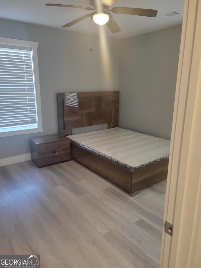 bedroom featuring hardwood / wood-style flooring and ceiling fan