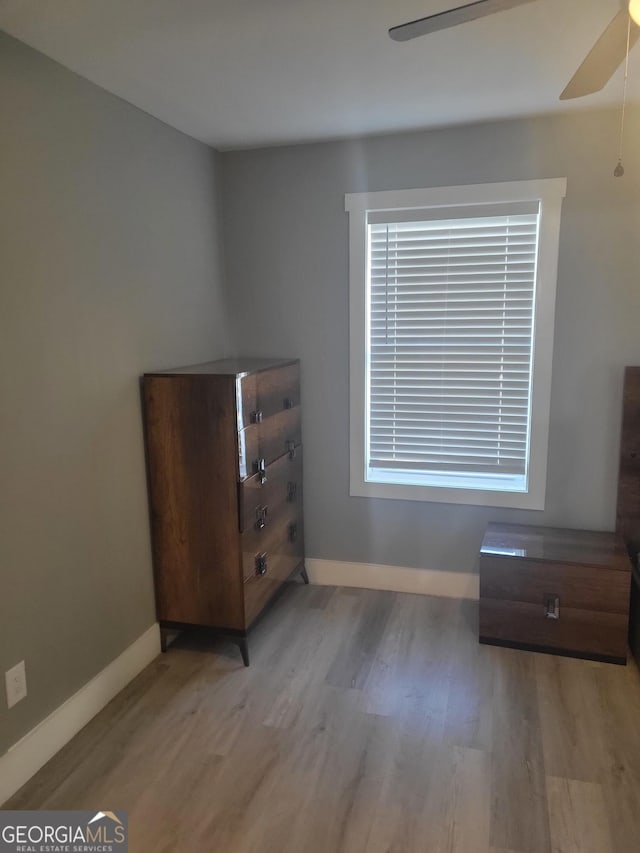 unfurnished bedroom with ceiling fan and light hardwood / wood-style floors