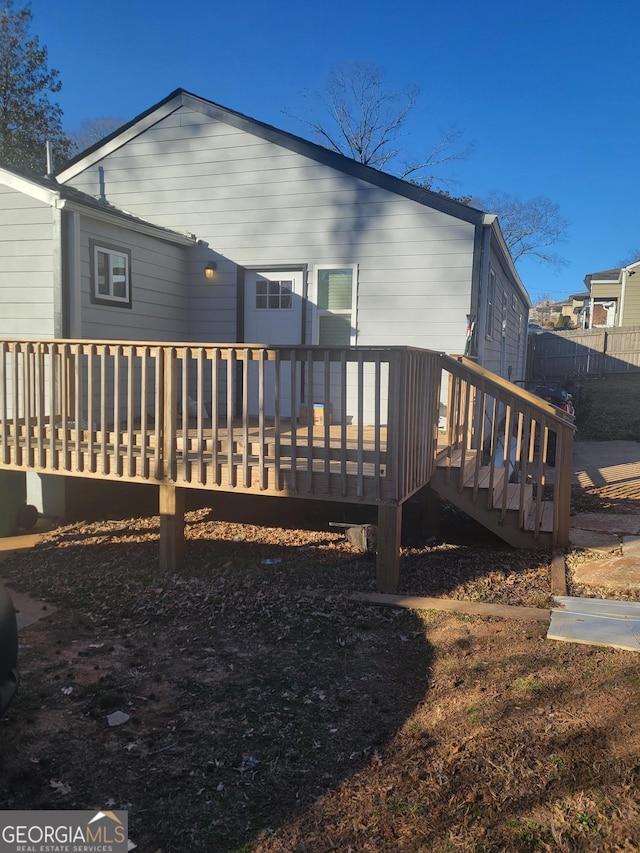 rear view of house featuring a wooden deck